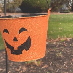 An orange pumpkin themed Halloween tin.