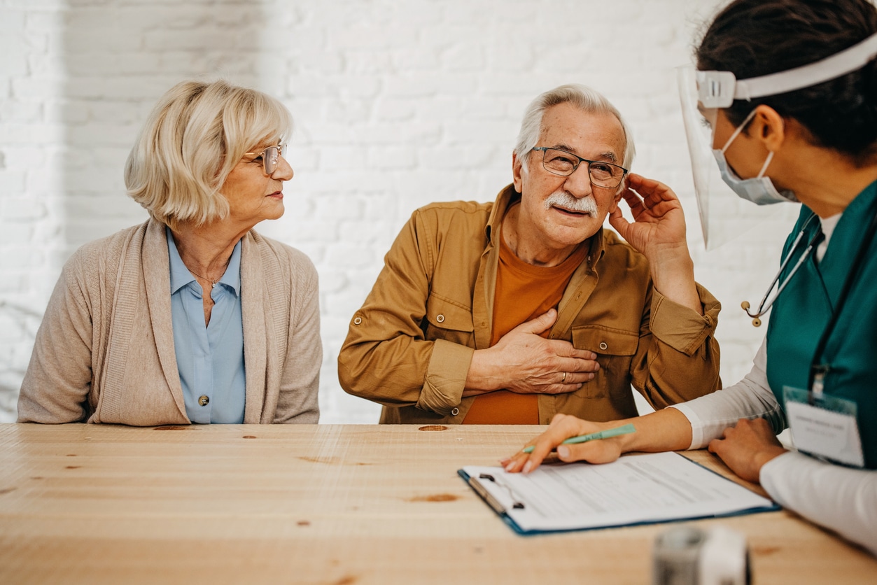 Man with hearing loss communicates with doctor