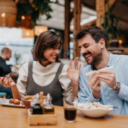 Two friends having dinner together