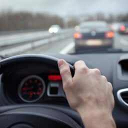 First person point of view of driving a car in traffic