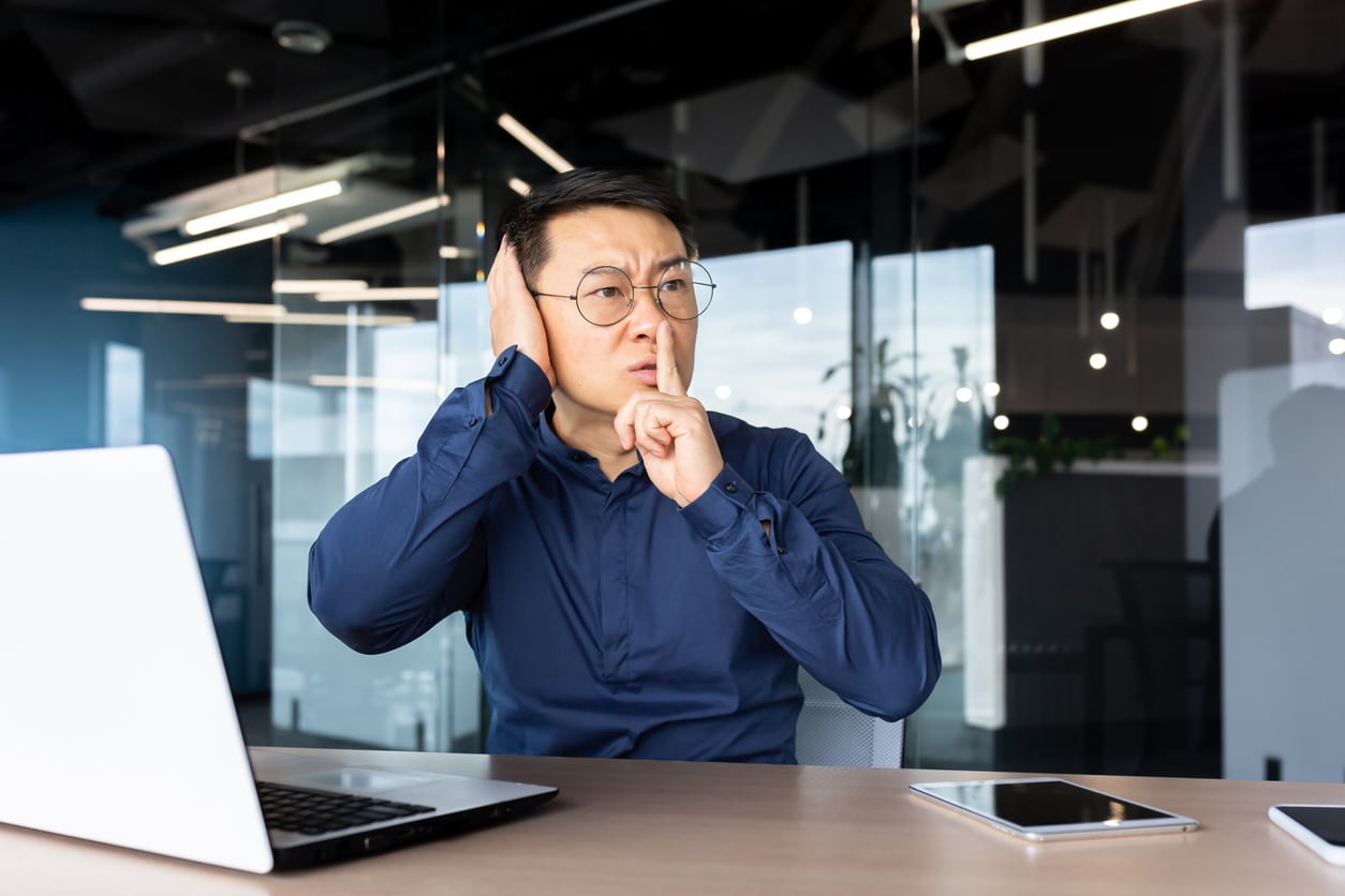 Man at work with tinnitus hushing his coworkers.