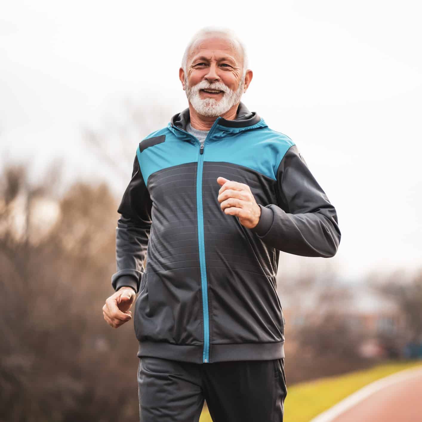 Smiling man going for a jog in the winter to stay active.