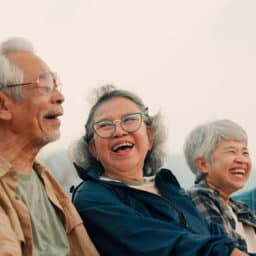 Group of senior friends laughing together.