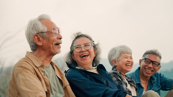 Group of senior friends laughing together.